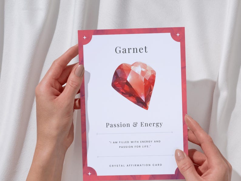 Garnet crystal affirmation card reading passion and energy held in two hands