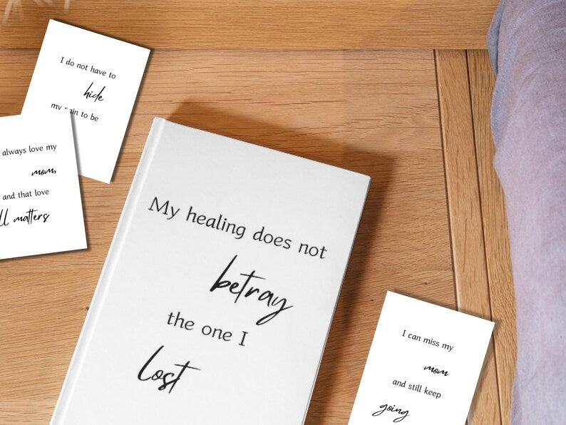 White journal reading my healing does not betray the one I lost surrounded by grief cards