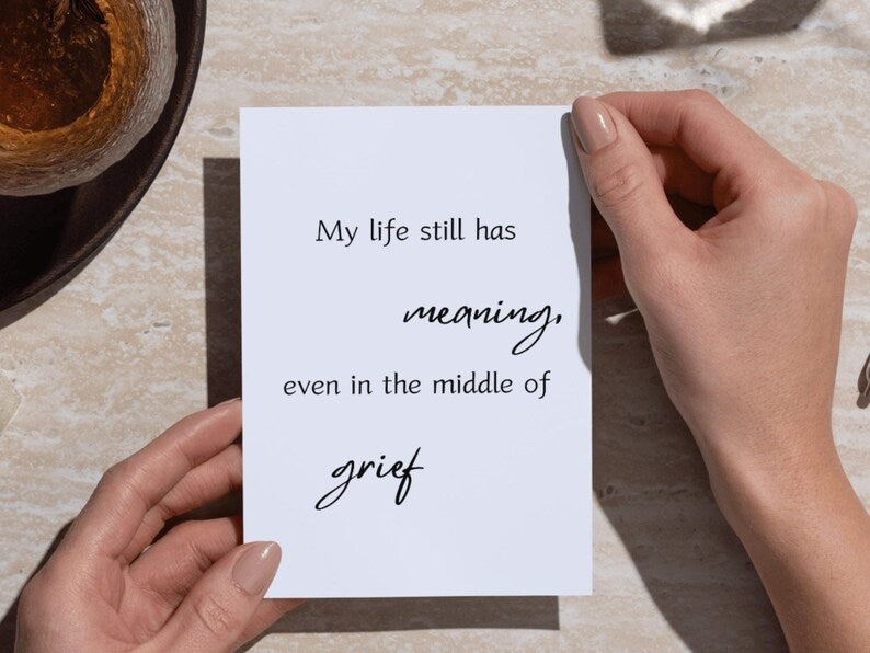 Card reading my life still has meaning even in the middle of grief held in two hands