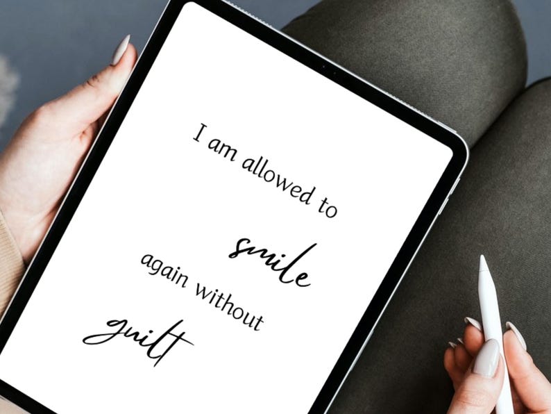 Tablet showing the affirmation I am allowed to smile again without guilt