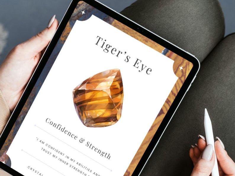 Tablet showing a Tiger's Eye crystal card reading confidence and strength