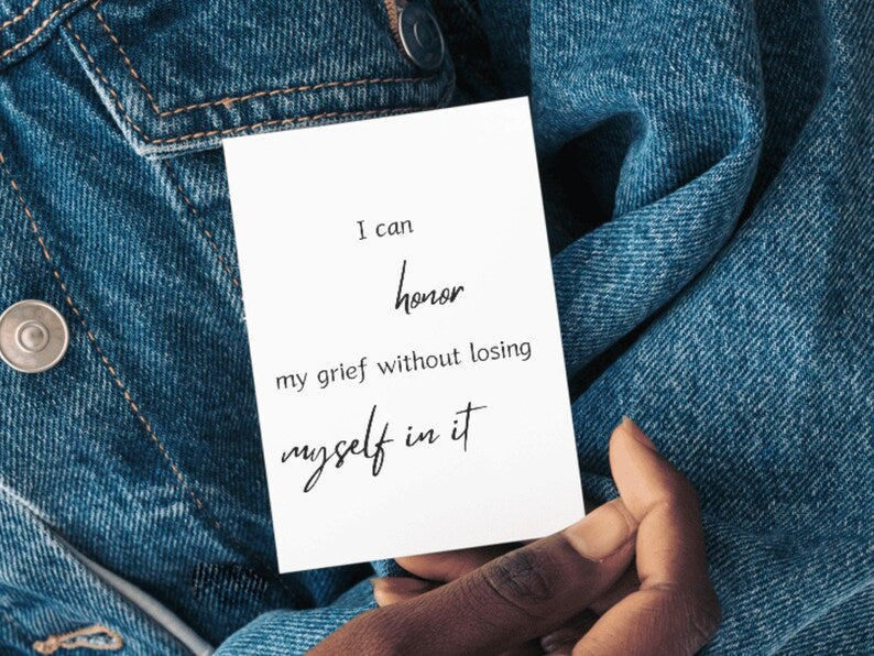 Card reading I can honor my grief without losing myself in it held against a denim background
