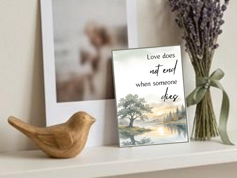 Wooden bird figurine and framed print love does not end when someone dies with dried lavender on a shelf