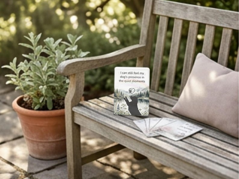 Wooden bench with a pink pillow and a card reading I can still feel my dogs presence in the quiet moments
