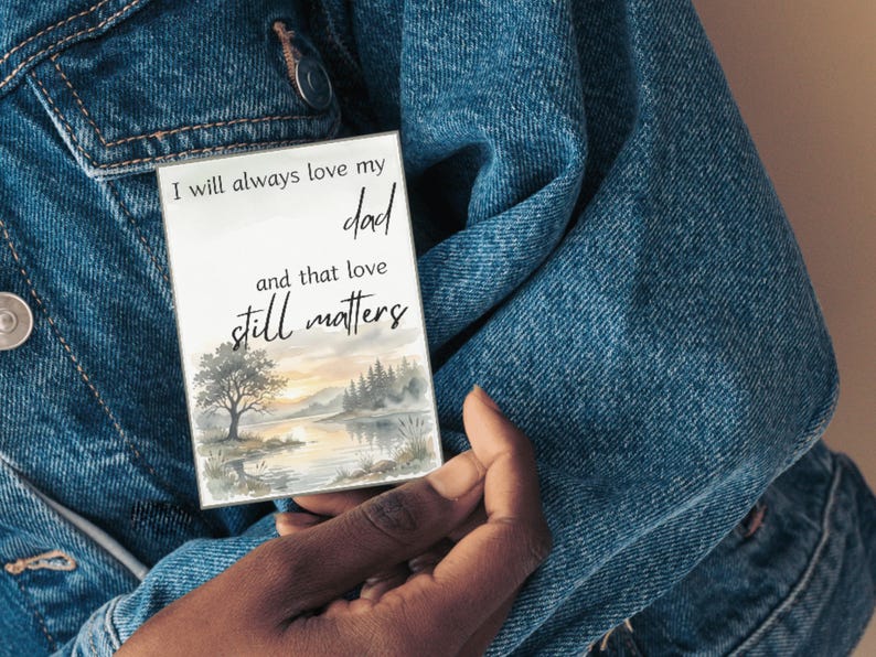 Card reading I will always love my dad and that love still matters held against a denim jacket