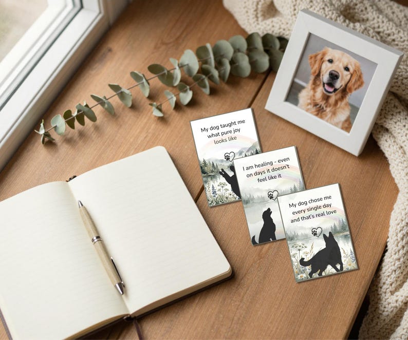 Wooden desk with a framed golden retriever photo, three dog silhouette cards, a notebook and pen