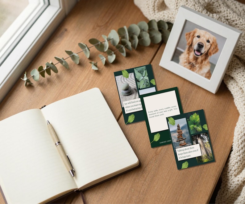 Open grief journal beside three affirmation cards and a framed golden retriever on a wooden window seat